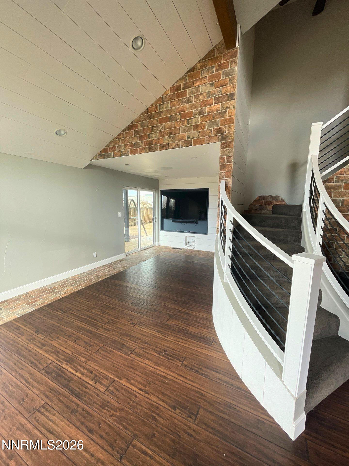 2205 Stowe Drive Reno, NV 89511 - Photo 2 of 17 a view of an empty room with wooden floor fireplace and a window