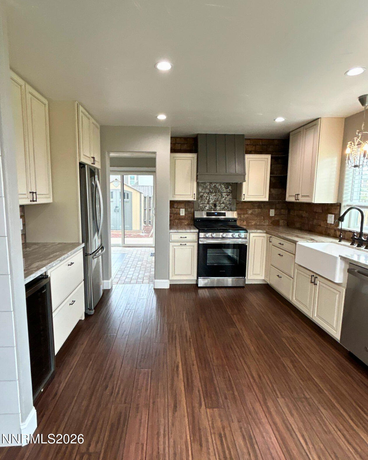 2205 Stowe Drive Reno, NV 89511 - Photo 4 of 17 a kitchen with wooden floors and stainless steel appliances