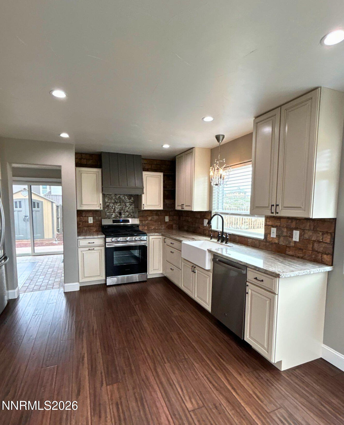 2205 Stowe Drive Reno, NV 89511 - Photo 5 of 17 a large kitchen with stainless steel appliances granite countertop a stove a sink dishwasher and a oven with wooden floor