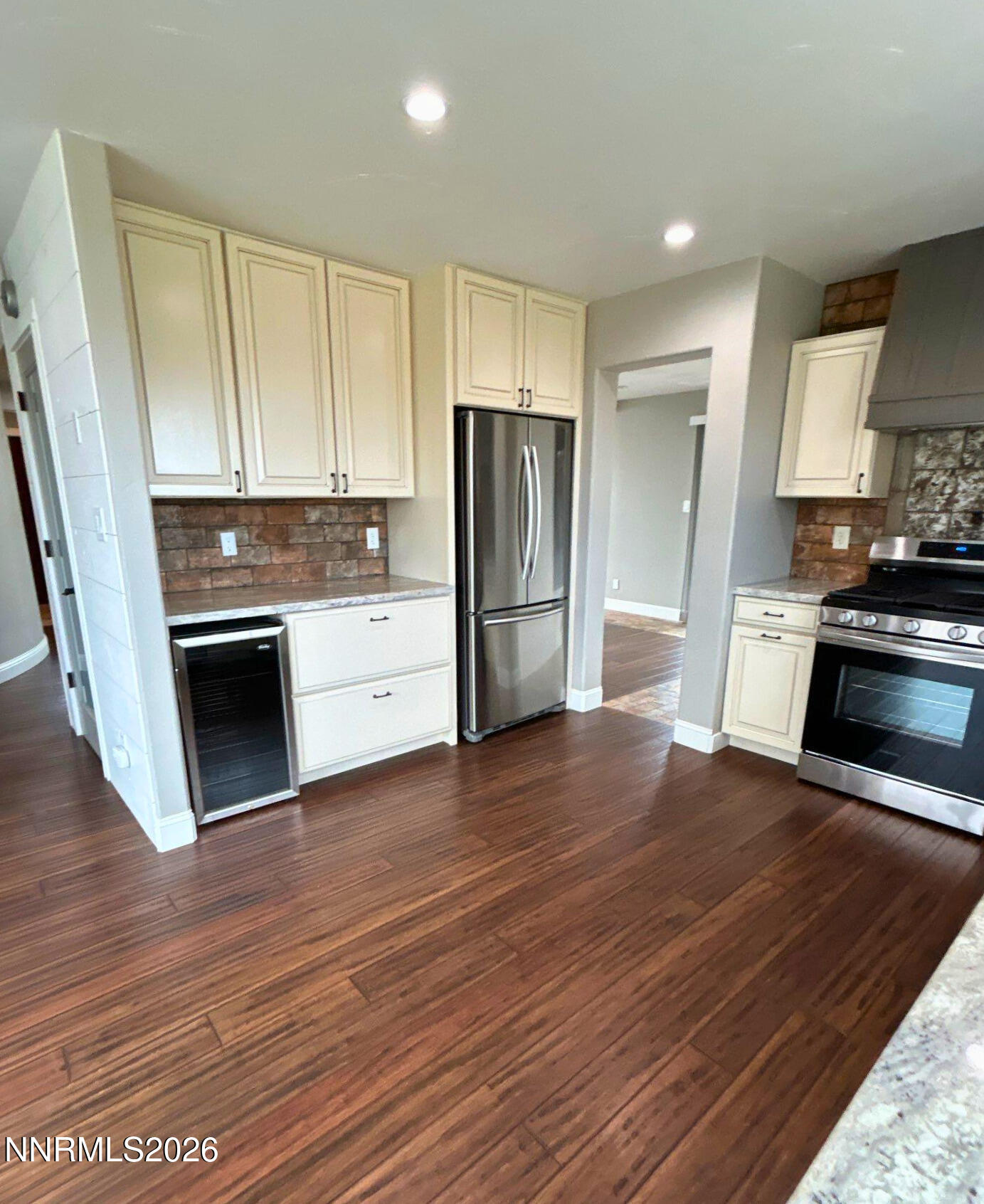 2205 Stowe Drive Reno, NV 89511 - Photo 6 of 17 a kitchen with granite countertop a refrigerator and a stove top oven
