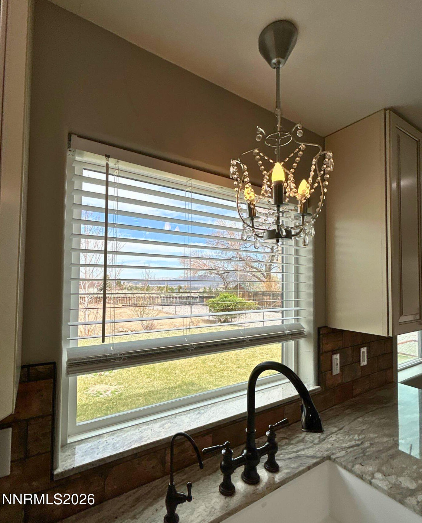 2205 Stowe Drive Reno, NV 89511 - Photo 7 of 17 a view of a room with a large window and chandelier
