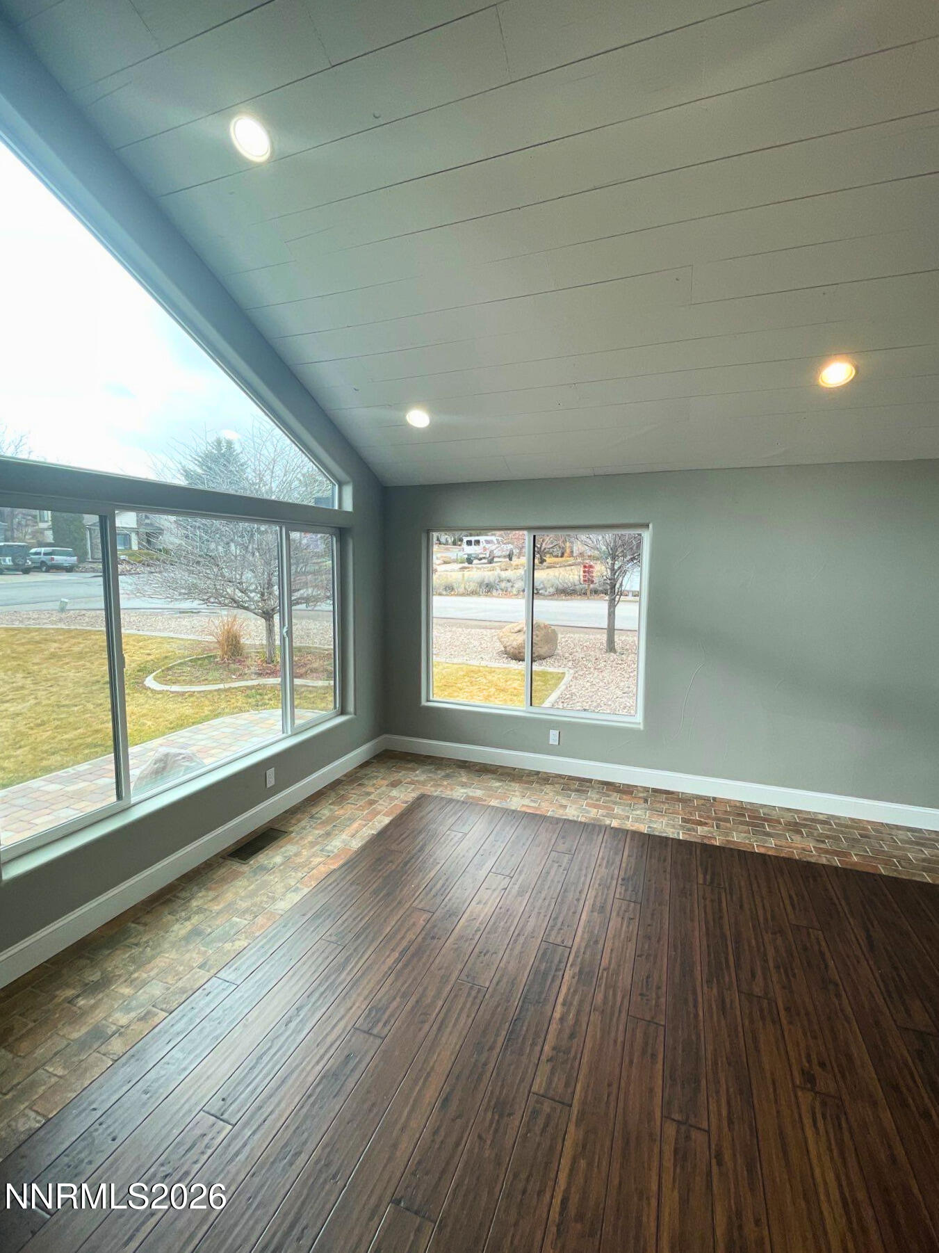 2205 Stowe Drive Reno, NV 89511 - Photo 9 of 17 an empty room with wooden floor and windows