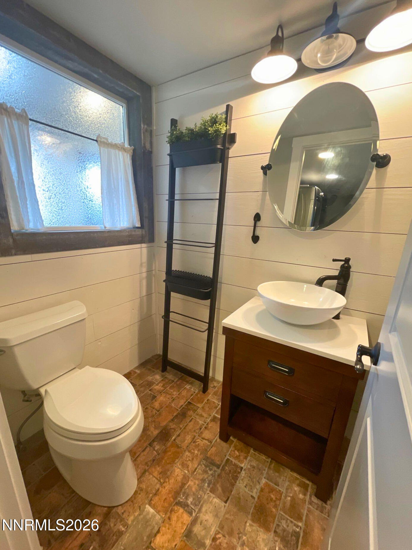 2205 Stowe Drive Reno, NV 89511 - Photo 10 of 17 a bathroom with a toilet sink and mirror