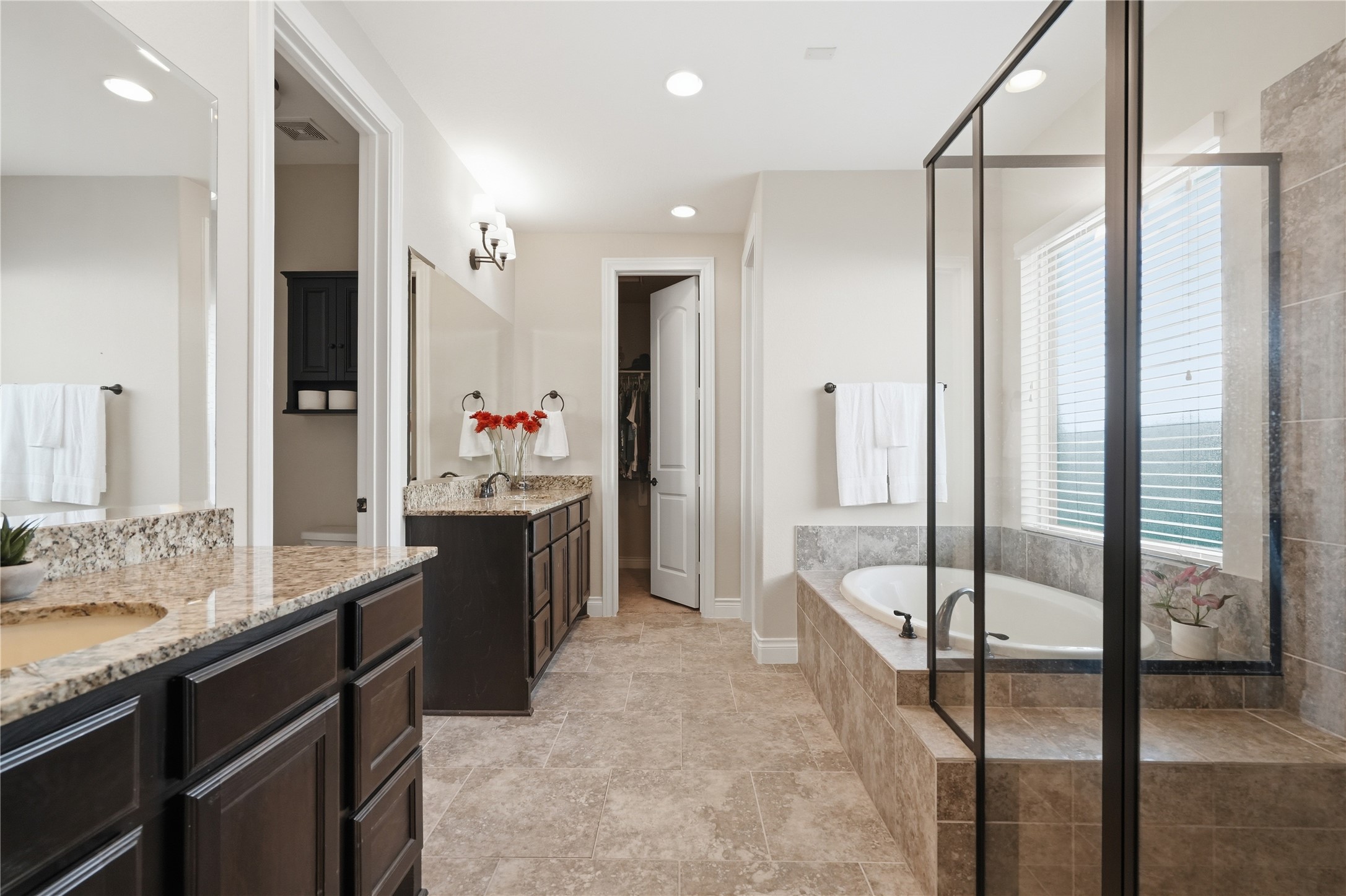 6429 Remlap Street Houston, TX 77055 - Photo 14 of 30 Primary bathroom with dual sinks, soaking tub, walk in shower, water closet, and his & her closets.