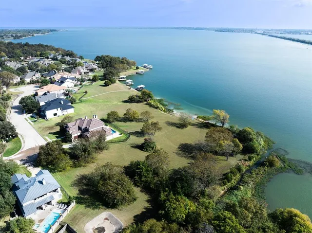 an aerial view of a house with a lake view