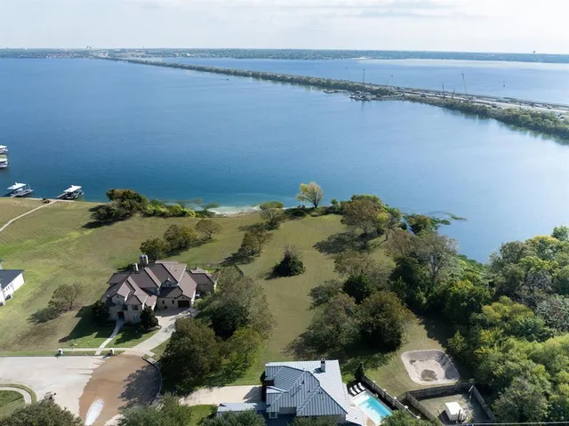 an aerial view of a house with a lake view