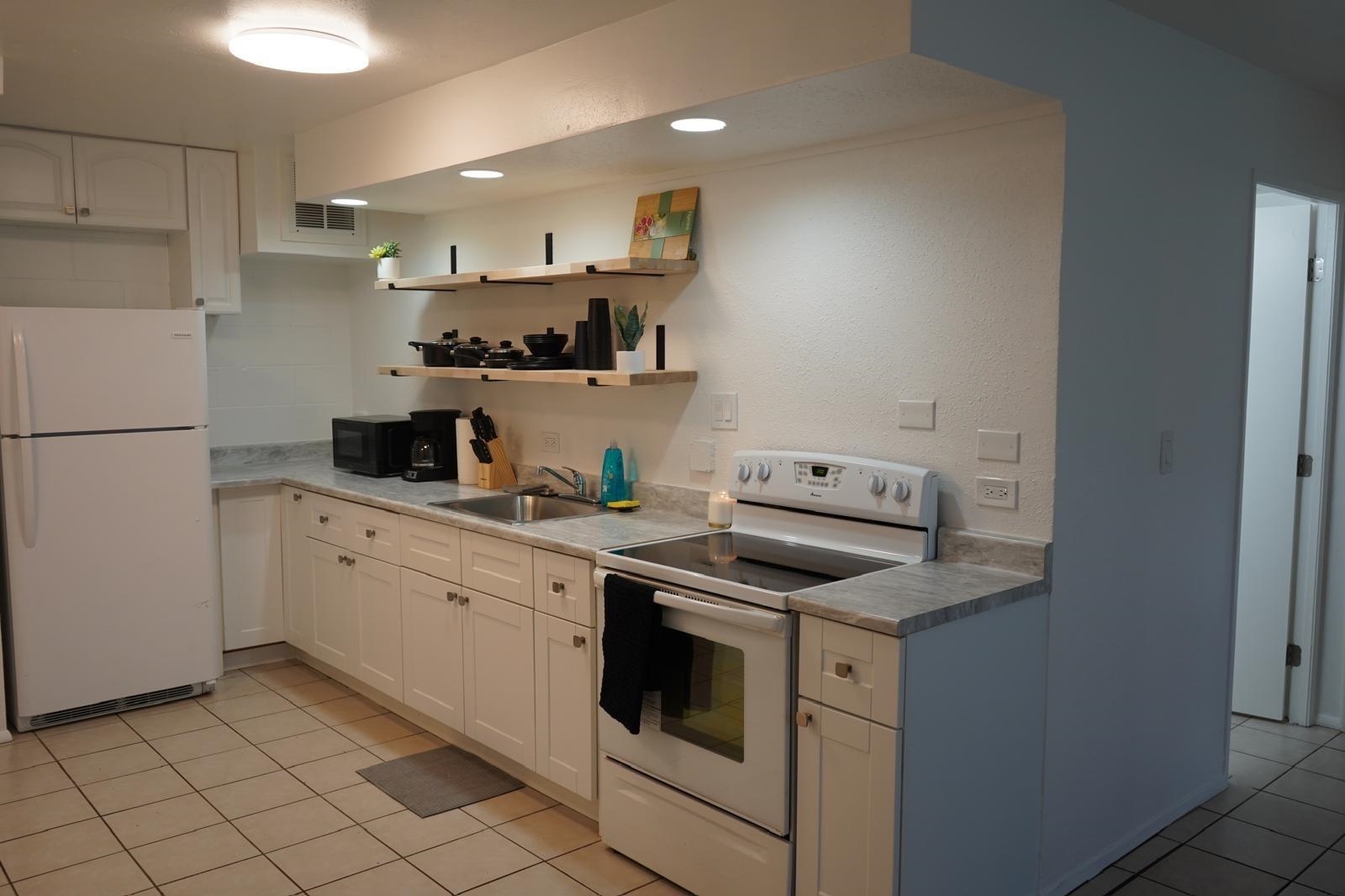 111 Kahului Beach Road, Unit C116 Kahului, HI 96732 - Photo 4 of 14 a kitchen with a stove sink and cabinets