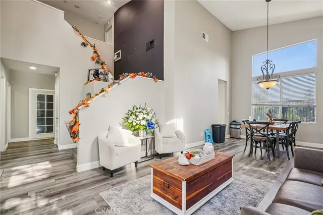 a living room with furniture a window and a potted plant