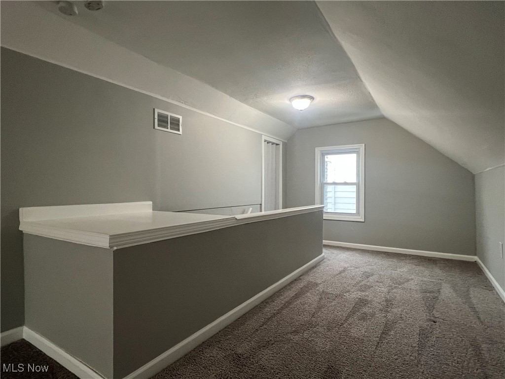 20611 Franklin Road Maple Heights, OH 44137 - Photo 24 of 31 Bedroom with lofted ceiling, carpet flooring, and a textured ceiling