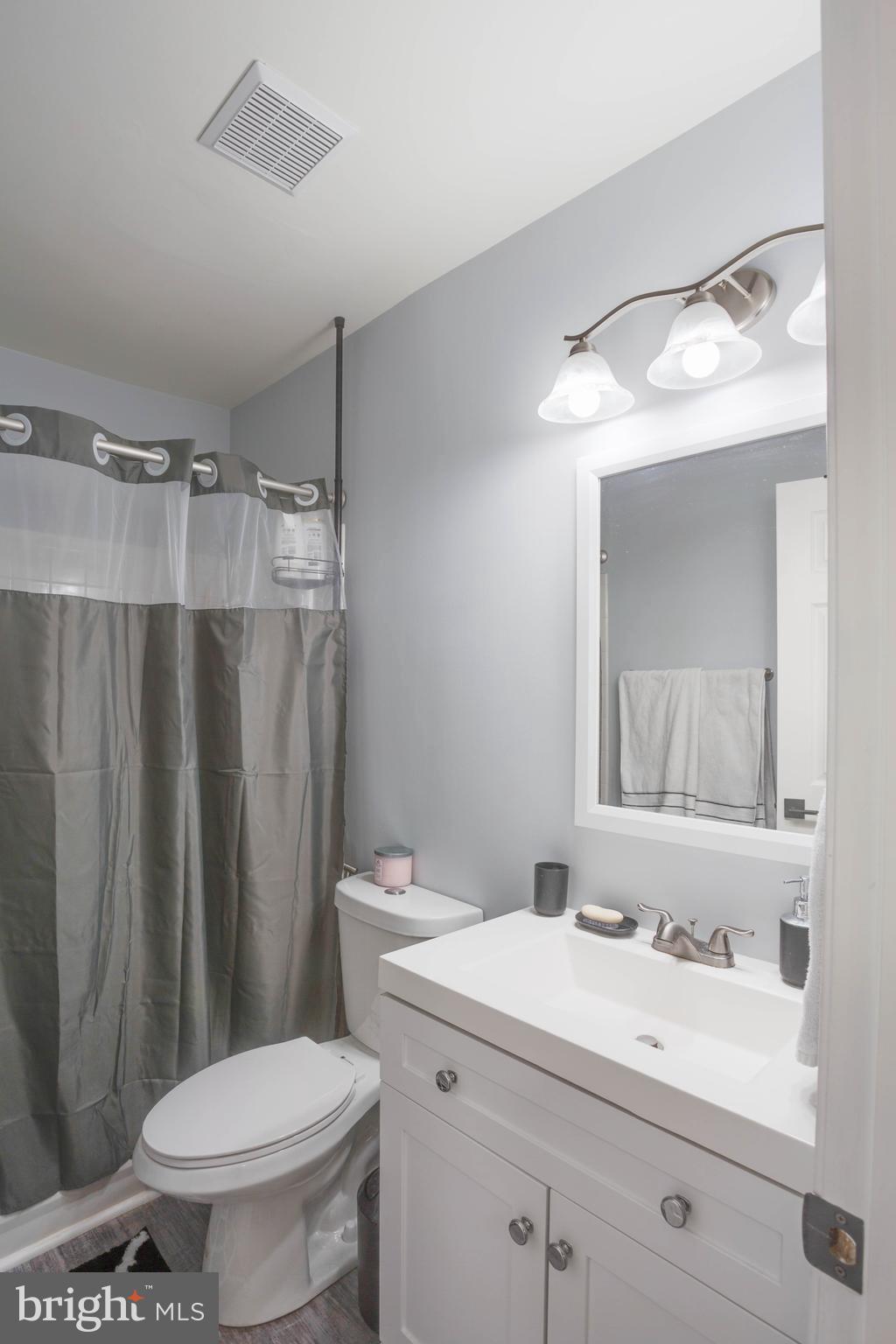 1049 Gardenview Loop, Unit 201 Woodbridge, VA 22191 - Photo 10 of 16 a bathroom with a sink toilet and shower