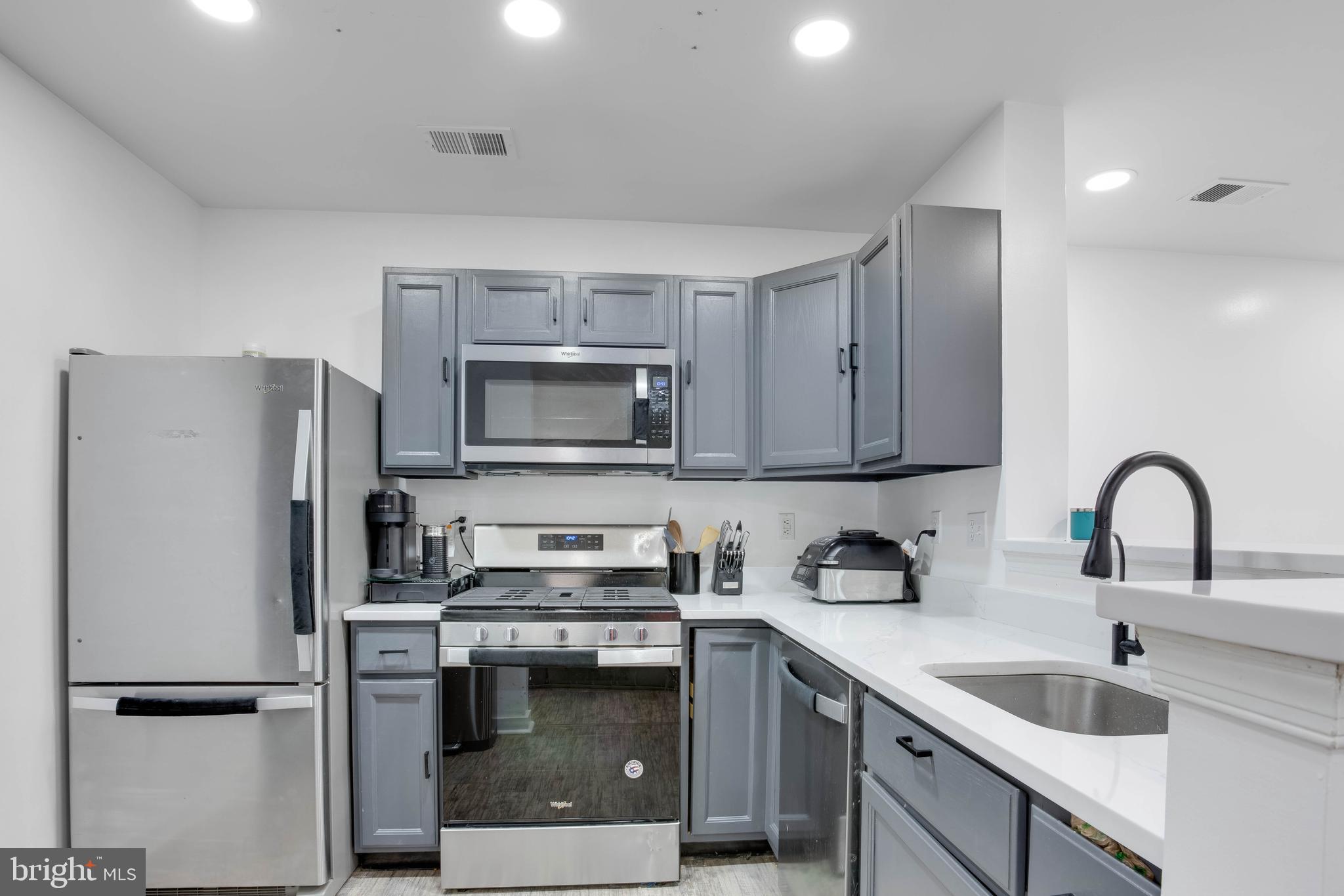 1049 Gardenview Loop, Unit 201 Woodbridge, VA 22191 - Photo 3 of 16 a kitchen with a refrigerator sink and microwave