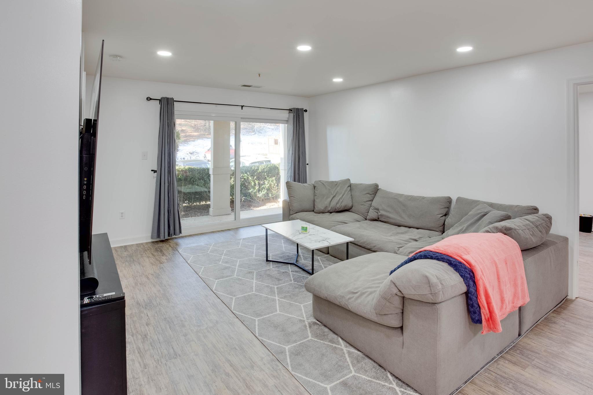 1049 Gardenview Loop, Unit 201 Woodbridge, VA 22191 - Photo 5 of 16 a living room with furniture and a large window