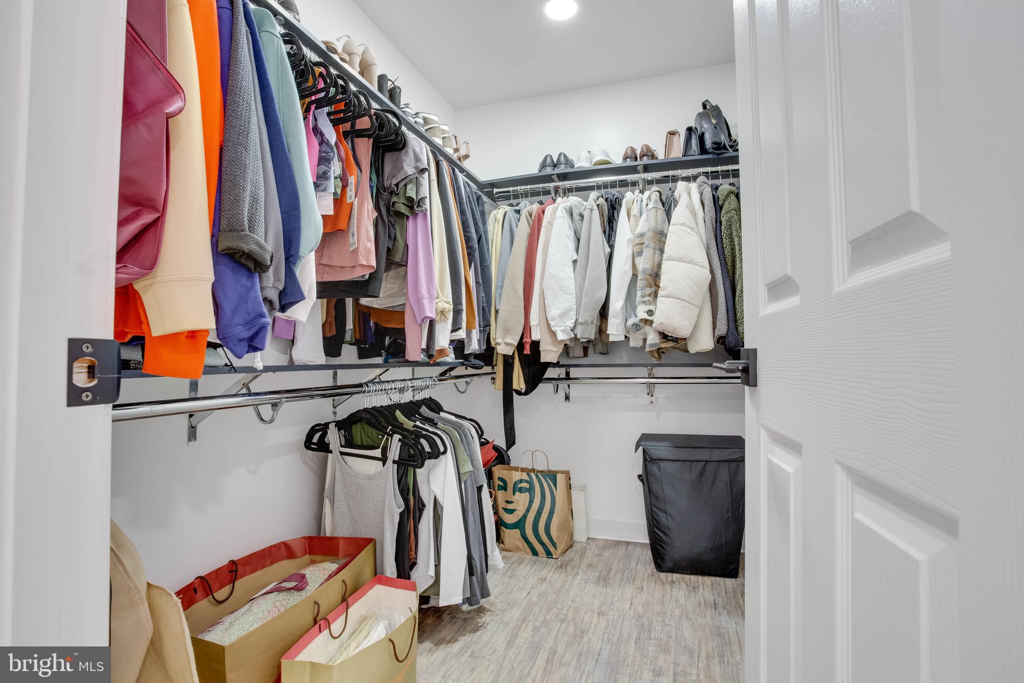 1049 Gardenview Loop, Unit 201 Woodbridge, VA 22191 - Photo 9 of 16 a view of walk in closet with clothes and shoes