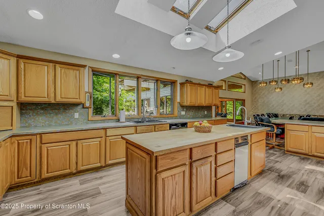 a view of a dining room with furniture wooden floor and chandelier