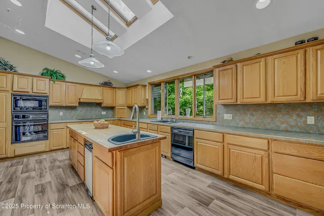 a living room with furniture a fireplace and large windows