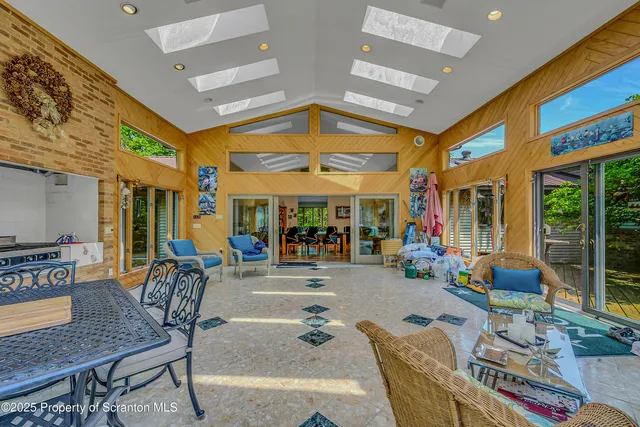 a view of a kitchen with kitchen island a counter top space a sink stainless steel appliances and cabinets