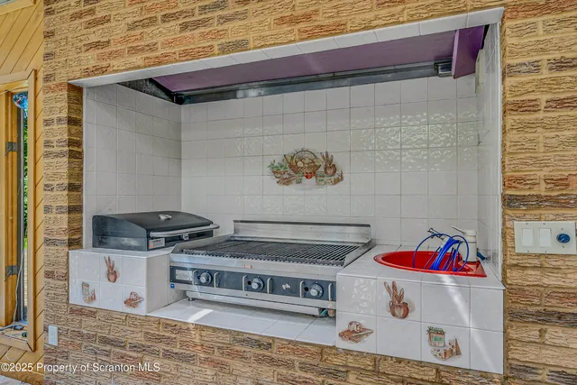 a view of open kitchen with granite countertop cabinets and a sink