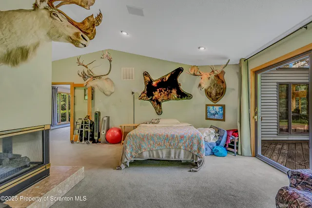a bedroom with furniture and a large window