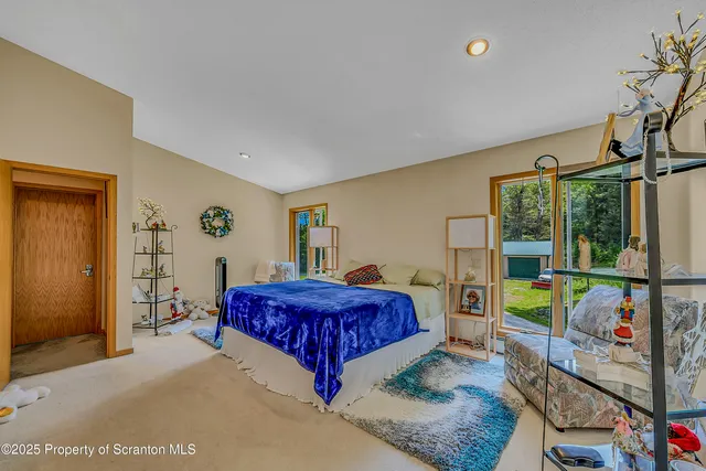 a bedroom with a bed and a mirror