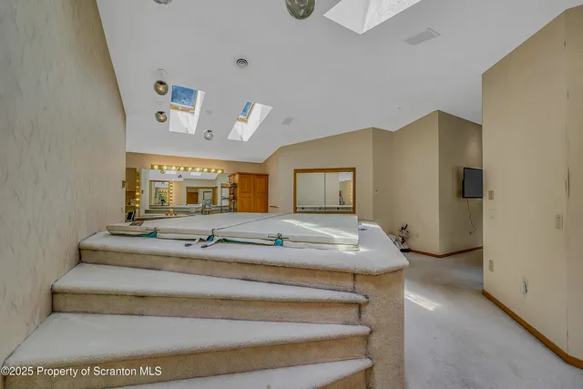 a bathroom with a sink vanity mirror and toilet