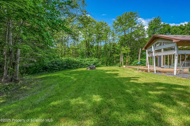 a living room with furniture and large windows