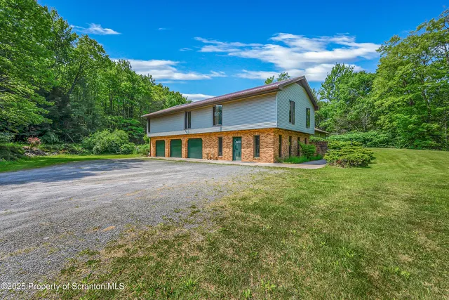 a living room with furniture and large windows