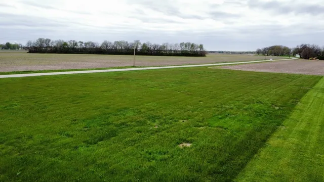 a view of a lake with houses in back
