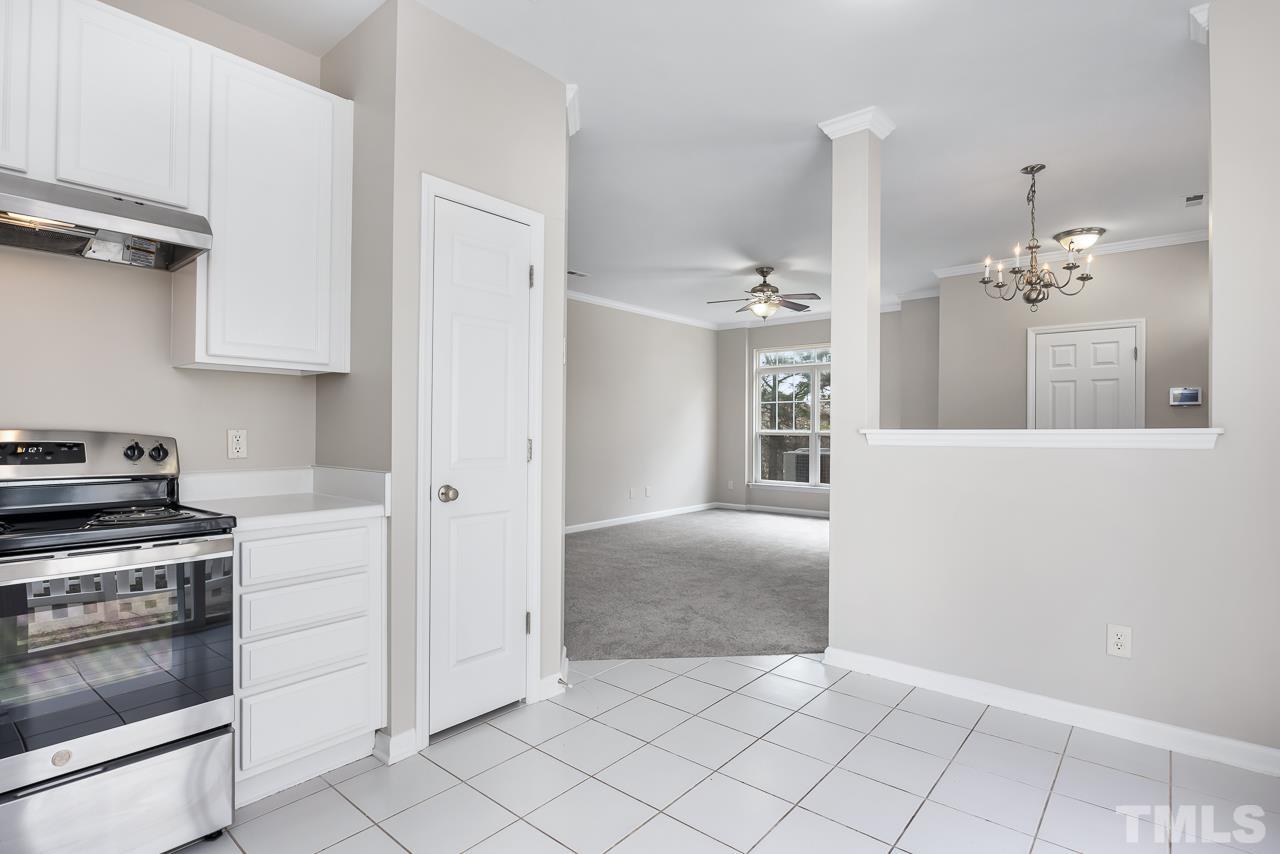 330 Gilman Lane, Unit 111 Raleigh, NC 27610 - Photo 11 of 26 a open kitchen with cabinets and stainless steel appliances