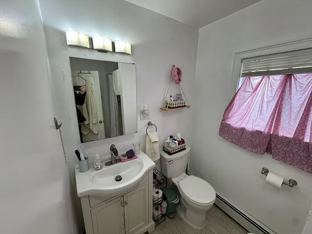 a bathroom with a toilet sink and mirror