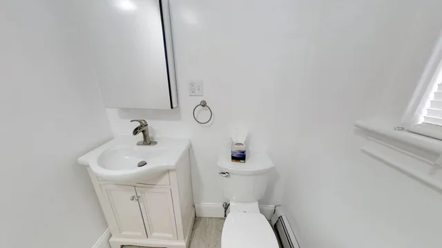 a bathroom with a sink a toilet and a mirror