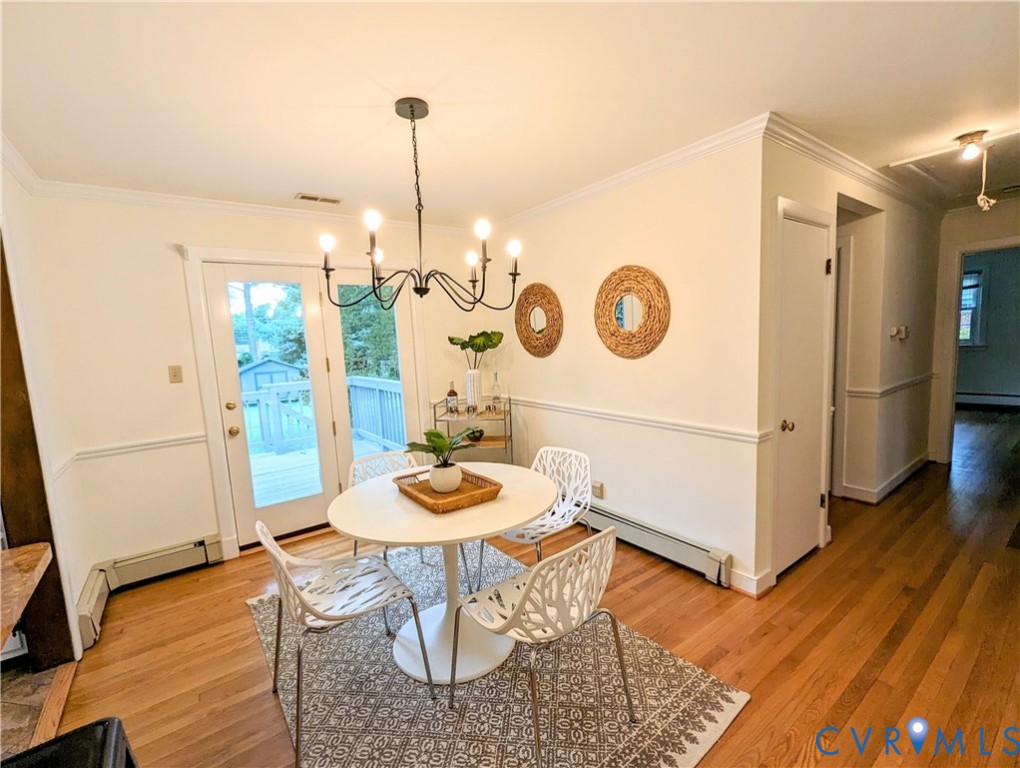 8401 Bronwood Road Henrico, VA 23229 - Photo 5 of 11 a view of a dining room with furniture wooden floor and a chandelier
