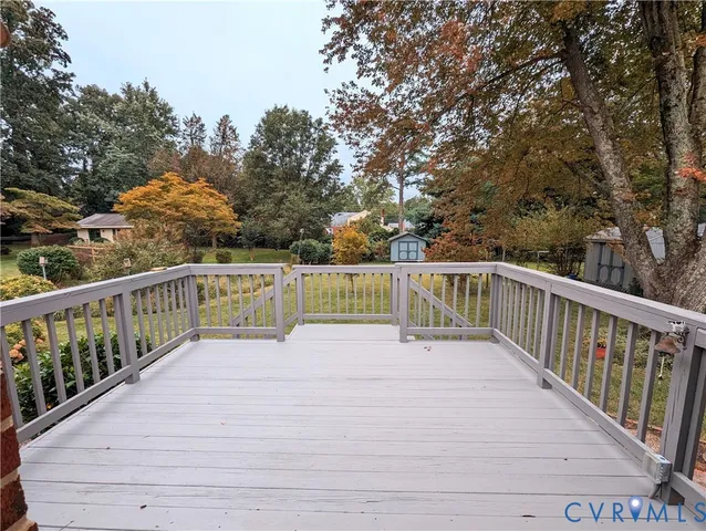 a view of balcony with wooden floor and fence