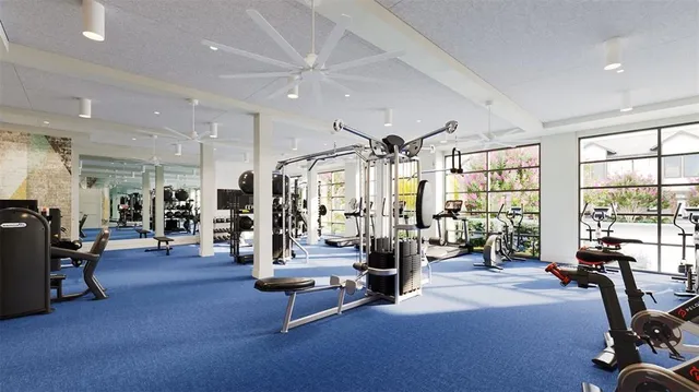 a living room with furniture gym equipment and a large window