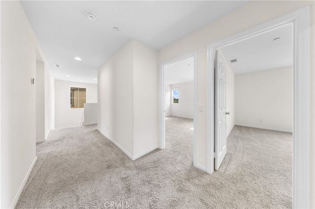 an empty room with a bathroom and a sink