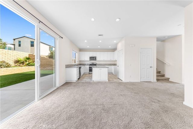 a view of a kitchen with a sink and refrigerator
