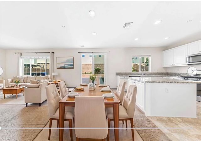 a living room with furniture a dining table and chairs