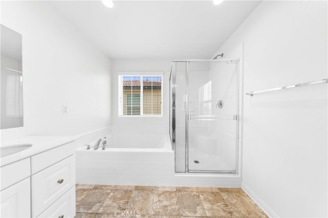 a spacious bathroom with a granite countertop sink a toilet and bathtub