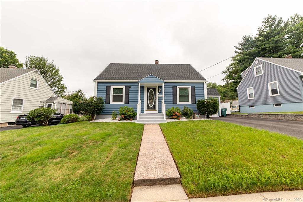 a front view of house with yard and green space