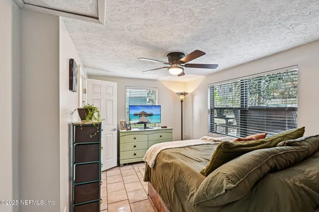 a kitchen with stainless steel appliances granite countertop a stove top oven a sink a refrigerator and a granite counter tops with white cabinets