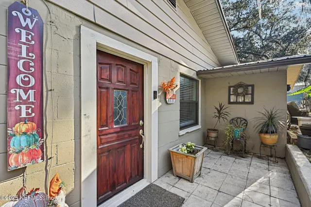 a dining room with furniture a flat screen tv and a large window
