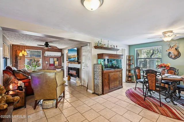 a living room with furniture ceiling fan and a flat screen tv