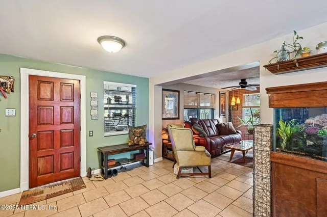 a living room with furniture a ceiling fan and a window