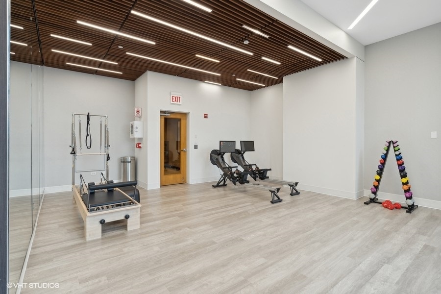 600 North Lake Shore Drive, Unit 1110 Chicago, IL 60611 - Photo 34 of 35 a room with gym equipment and a mirror