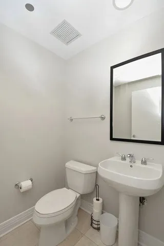 a bathroom with a sink toilet and mirror