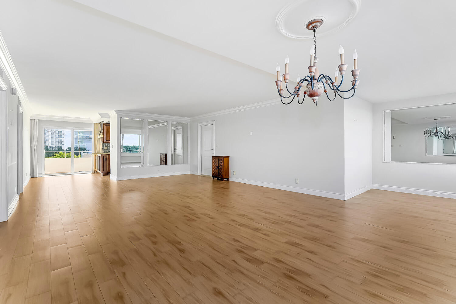 215 North Birch Road, Unit 5B Fort Lauderdale, FL 33304 - Photo 29 of 73 a view of a livingroom with wooden floor and a chandelier