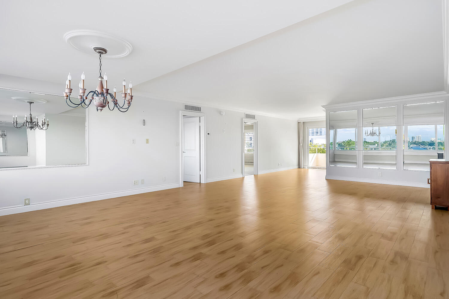 215 North Birch Road, Unit 5B Fort Lauderdale, FL 33304 - Photo 30 of 73 a view of empty room with wooden floor and floor to ceiling window