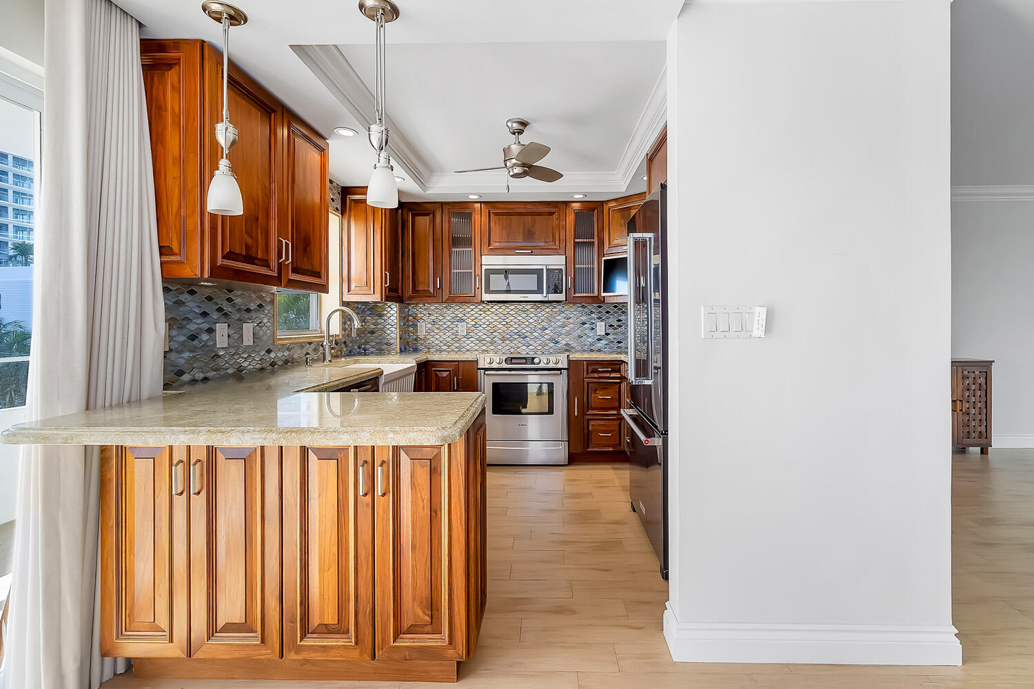 215 North Birch Road, Unit 5B Fort Lauderdale, FL 33304 - Photo 32 of 73 a hallway with a large window and stainless steel appliances