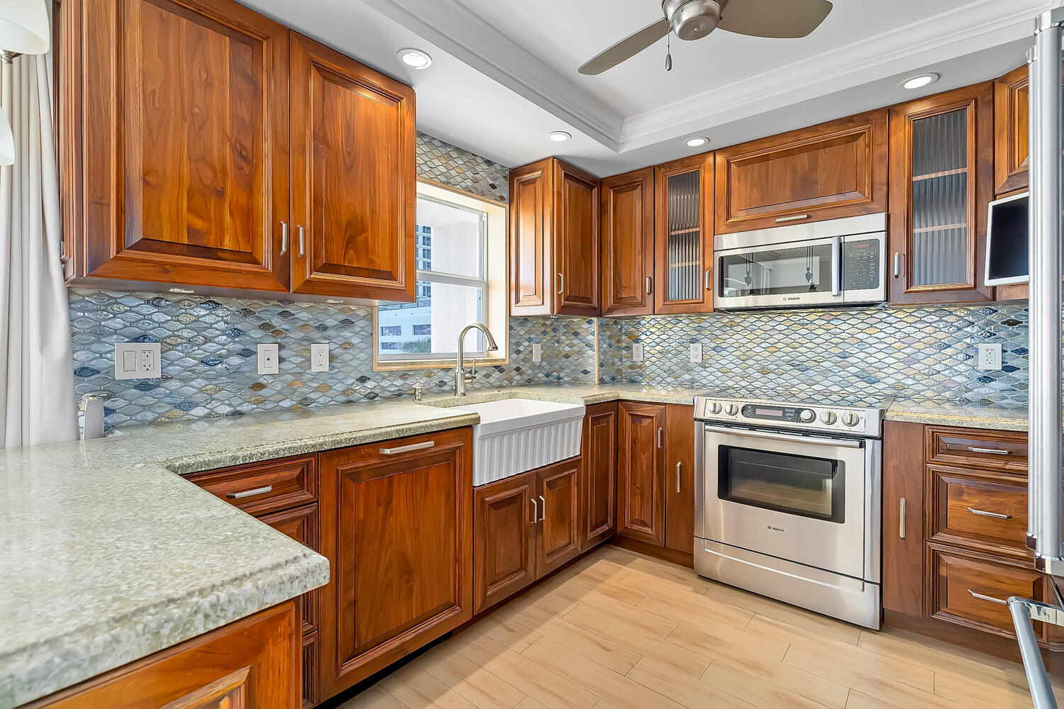 215 North Birch Road, Unit 5B Fort Lauderdale, FL 33304 - Photo 33 of 73 a kitchen with stainless steel appliances granite countertop wooden cabinets a sink and dishwasher