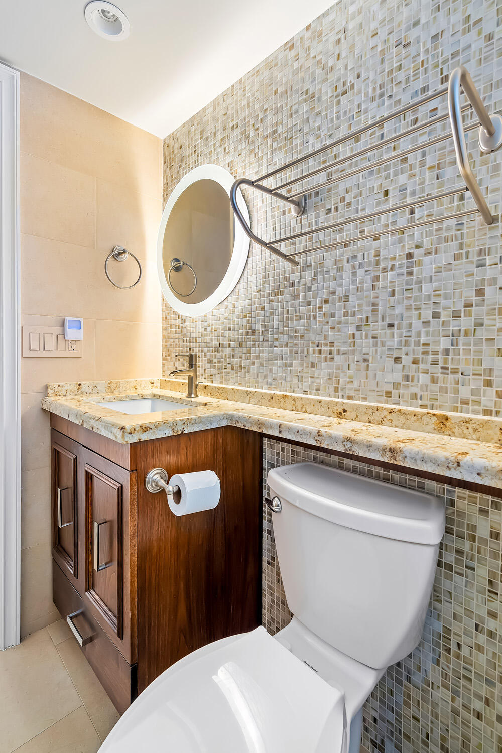 215 North Birch Road, Unit 5B Fort Lauderdale, FL 33304 - Photo 43 of 73 a bathroom with a toilet a sink and a mirror