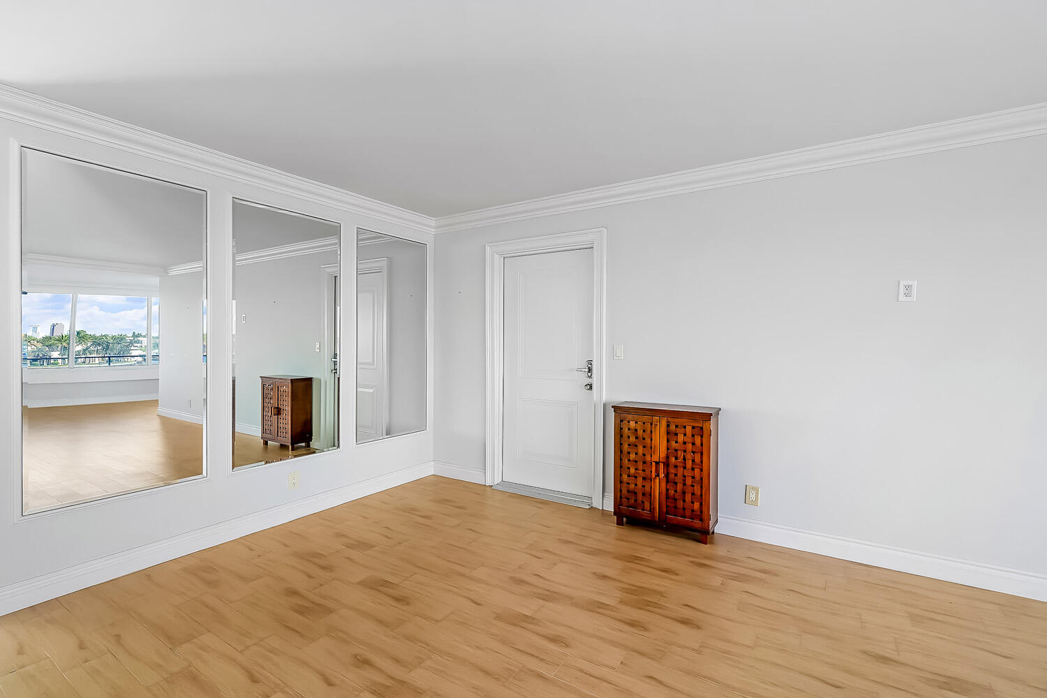 215 North Birch Road, Unit 5B Fort Lauderdale, FL 33304 - Photo 60 of 73 a view of an empty room with wooden floor and a window